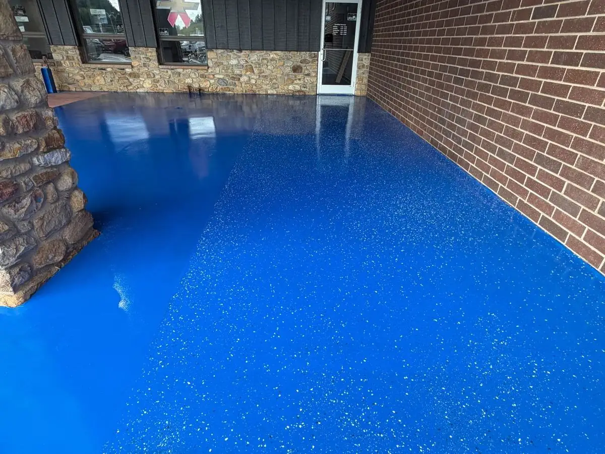 Blue epoxy floor with partial decorative flake in Boone