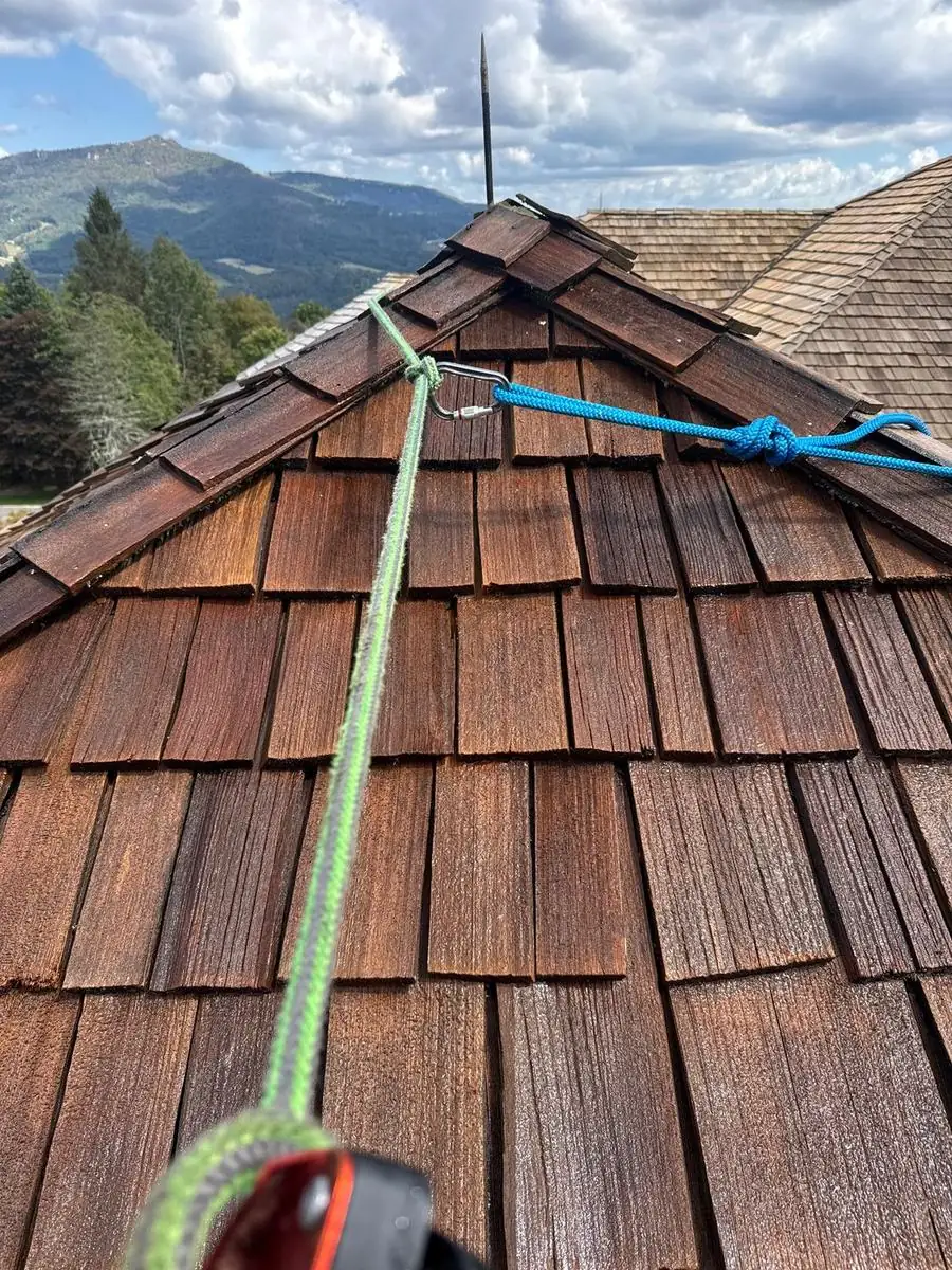 Close view of cleaned cedar shakes at a roof peak