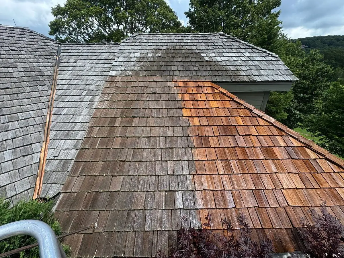 Cedar shake roof, gray on one side and restored on the other at Elk River in Banner Elk