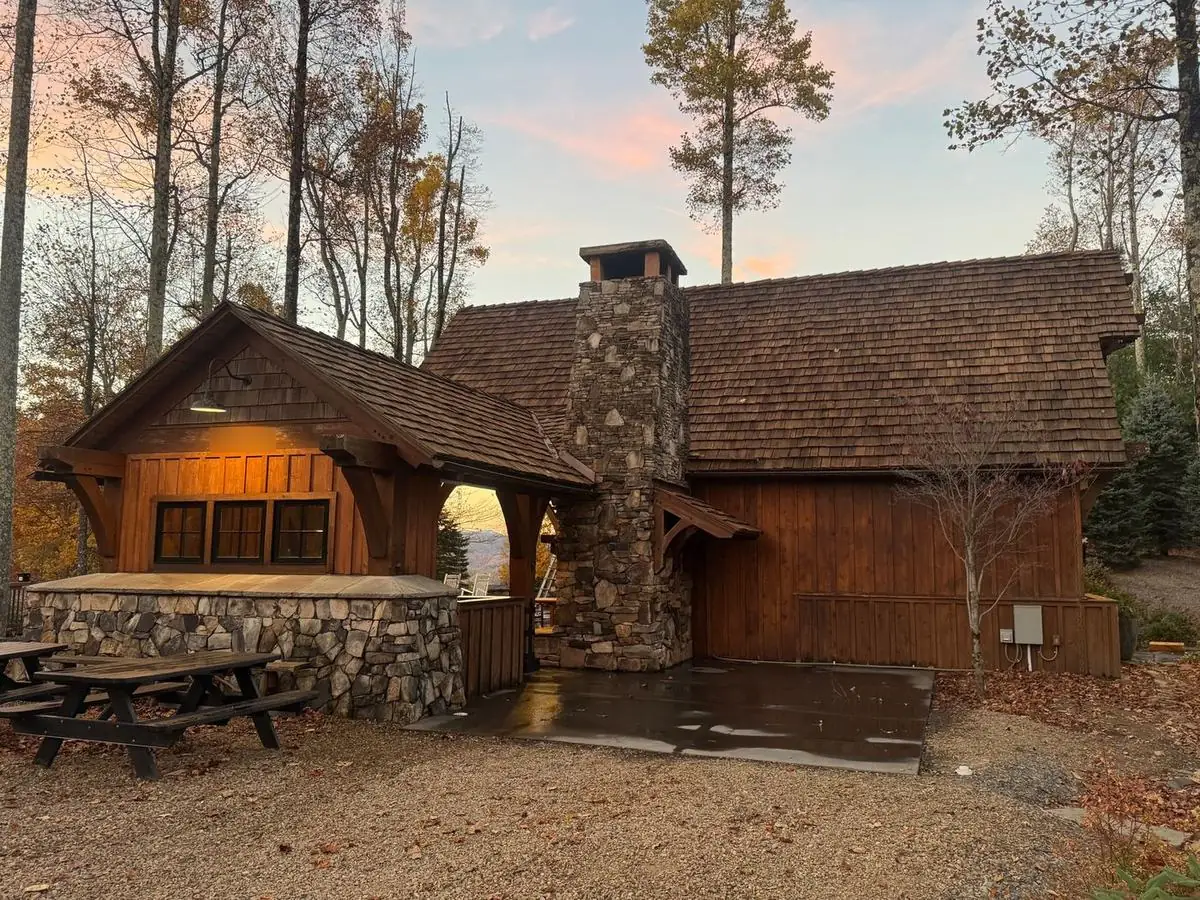 Restored cedar shake roof beside a stone chimney at Blue Ridge Mountain Club in Boone