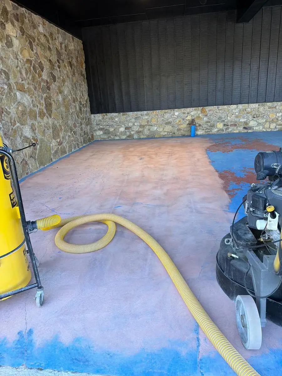 Concrete floor being ground to remove an old coating in Boone