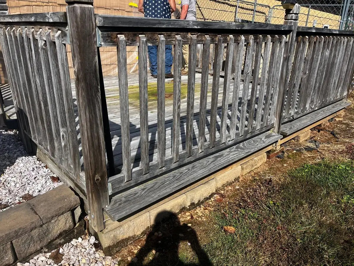 Weathered gray deck and railing before restoration in North Wilkesboro