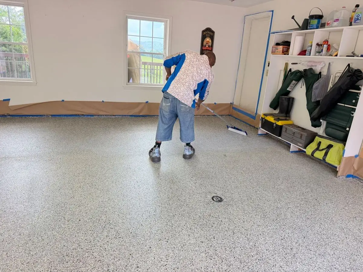 Full-flake epoxy floor being installed in a garage in Boone