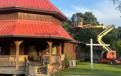 Metal roof cleaning boom lift red standing seam