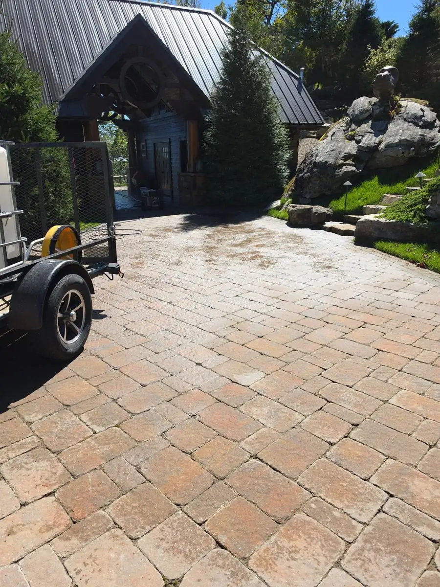 Paver driveway after cleaning, beside natural stone steps