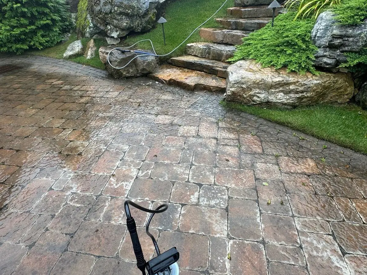 Pavers being cleaned beside natural stone steps