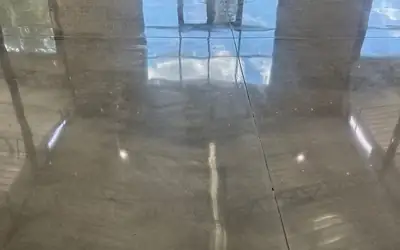 Polished concrete floor glossy reflections brick doors