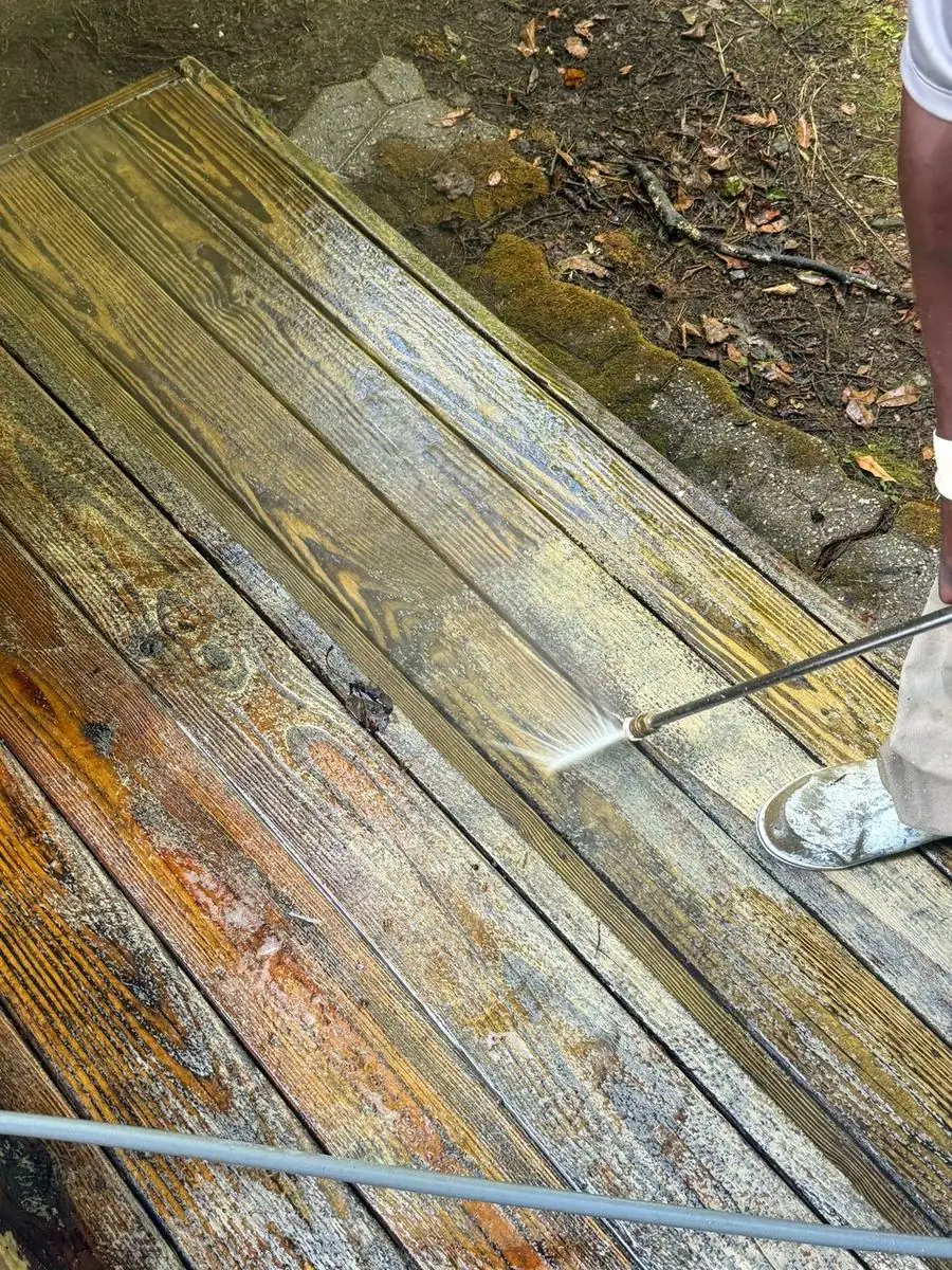Wood deck steps being pressure washed in Foscoe