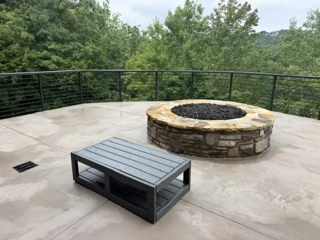 Stone fire pit on a concrete patio after cleaning at Blue Ridge Mountain Club in Boone