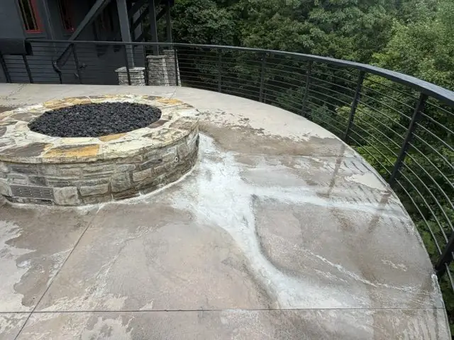 Stone fire pit and concrete patio before cleaning at Blue Ridge Mountain Club in Boone