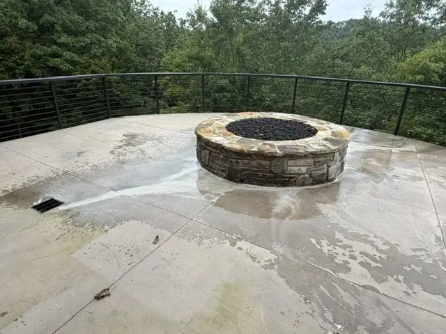 Stone fire pit and patio partway through cleaning at Blue Ridge Mountain Club in Boone