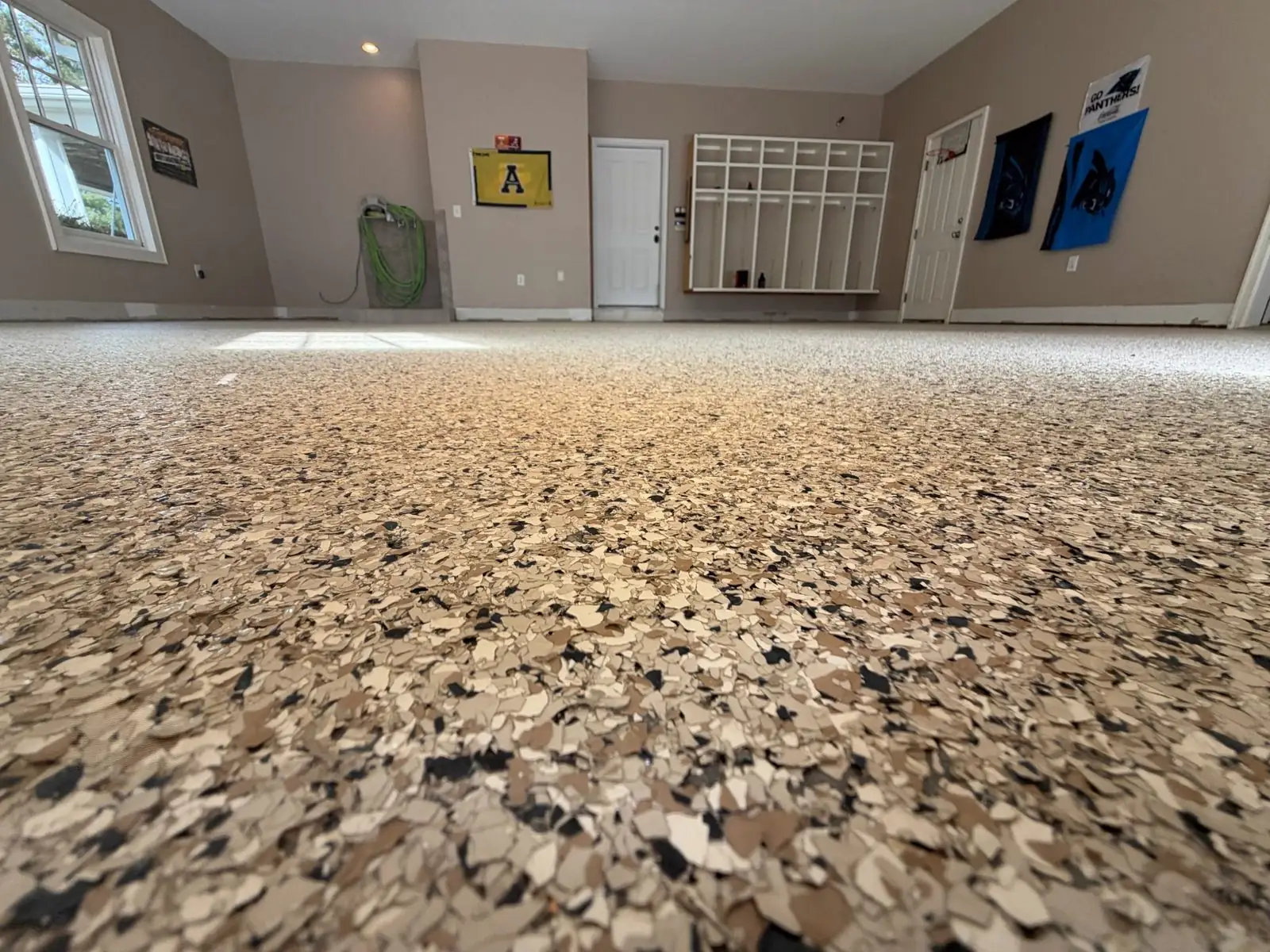 Finished tan and black flake epoxy garage floor in Boone